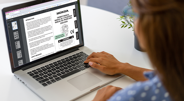 Customer reading owner's manual on laptop